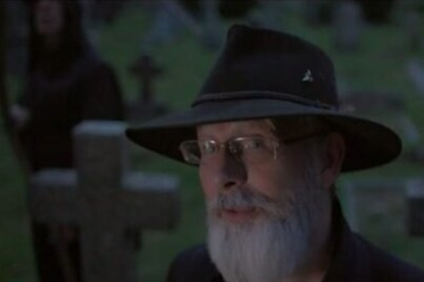 The actor Paul Kaye as Terry Pratchett in a graveyard
